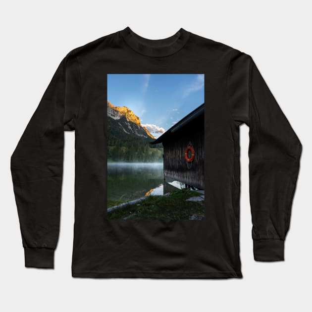 Boathouse with lifesaver Portrait. Amazing shot of a wooden house in the Ferchensee lake in Bavaria, Germany, in front of a mountain belonging to the Alps. Scenic foggy morning scenery at sunrise. Long Sleeve T-Shirt by EviRadauscher